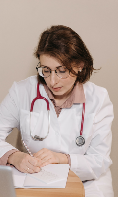 Female with stethescope writing on pad