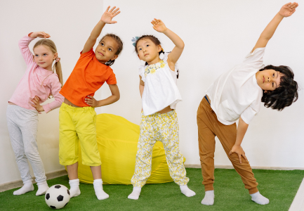 Four pre-school children stretching